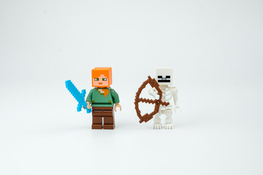 Two Minecraft-style block toy characters stand with a blue sword and brown bow on a white background. Suitable for pixel game toys, collectible figures on Apr 13, 2026 in Jakarta, Indonesia