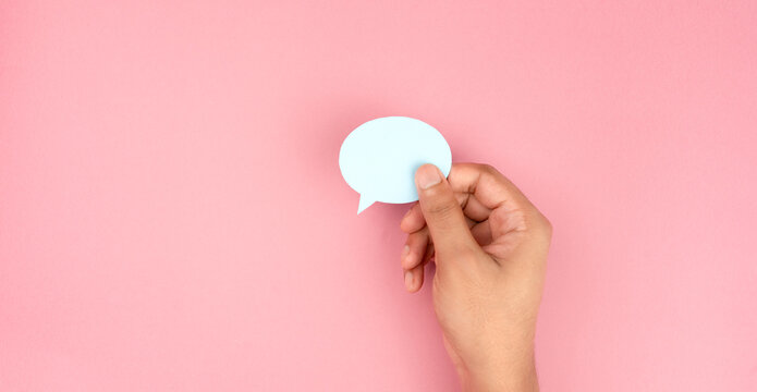 Hand Holding Blank Speech Bubble Card on Pink Background, Communication and Chat Message Concept
