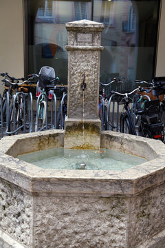 Historic fountain and bicycles in the historic center of Bressanone, South Tyrol, Italy