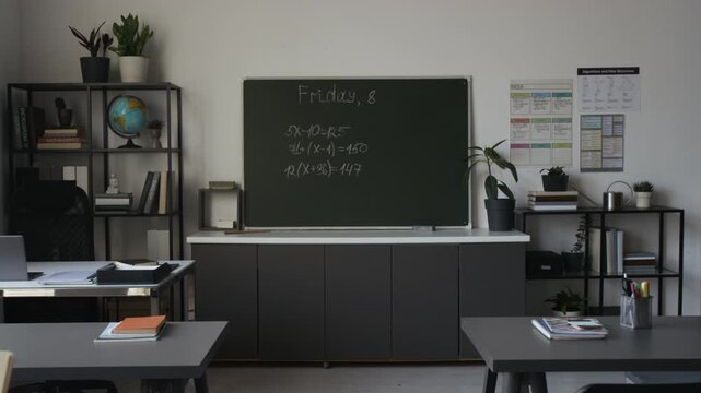 Empty modern classroom displaying blackboard with written math equations and desks with notebooks. Ideal for back-to-school marketing campaigns or educational promo videos