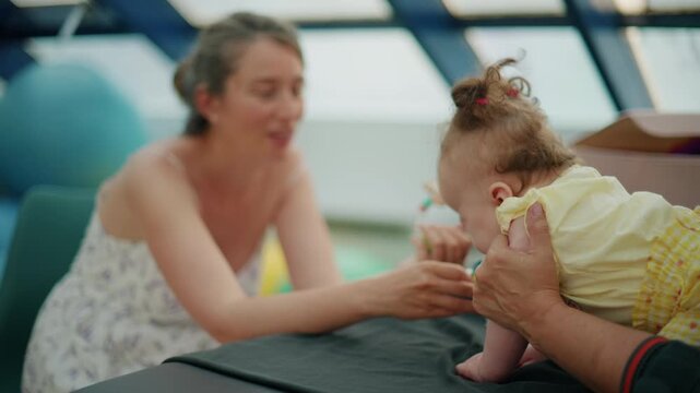 Mother engages with her infant, encouraging tummy time to promote physical development and early motor skill milestones
