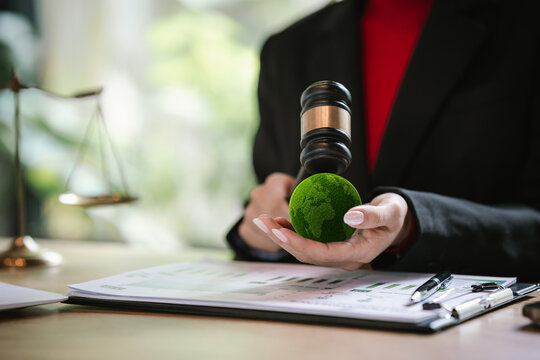 Judge's gavel above a green globe symbolizing environmental law, ESG compliance, climate justice, and sustainable governance.