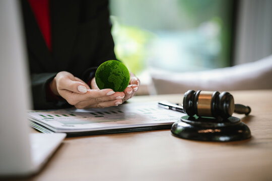 Judge's gavel above a green globe symbolizing environmental law, ESG compliance, climate justice, and sustainable governance.