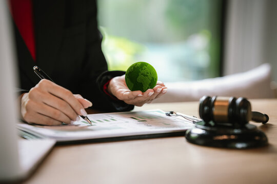 Judge's gavel above a green globe symbolizing environmental law, ESG compliance, climate justice, and sustainable governance.