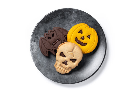 Assorted Halloween cookies isolated on white background. Halloween cookies filled with chocolate in the shape of bats, skulls and pumpkins