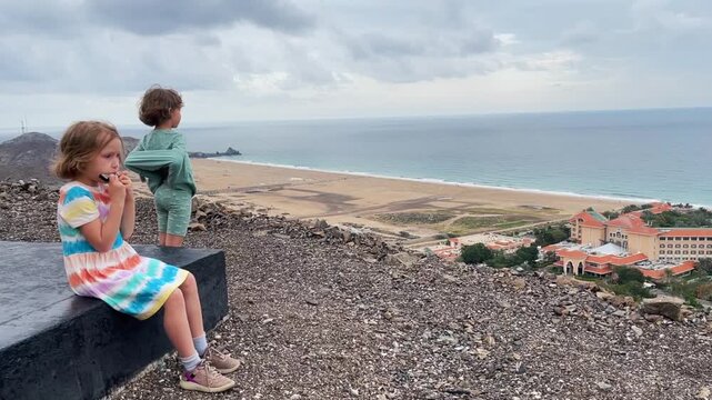 Children play the harmonica on the mountain trail