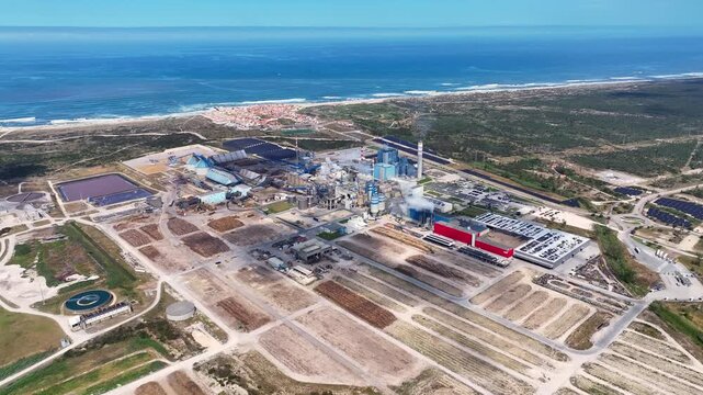 Aerial view of industrial pulp and paper mill plant near the ocean coast