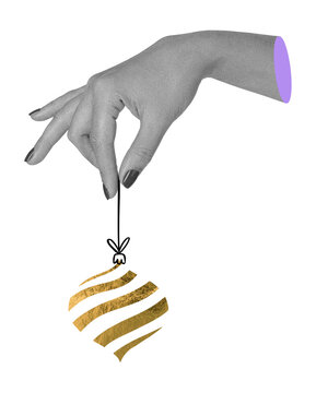 Surreal art collage with human hand holding a golden christmas tree ornament by a string on transparent background. Festive decor element, holiday magic and seasonal design