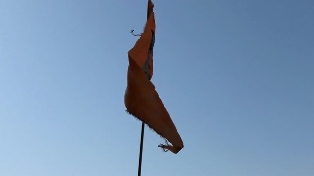 A flag with the image of Lord Shiva inscribed flying on the premises of Bhojeshwar Temple, an ancient incomplete temple in Bhojpur, Madhya Pradesh, India