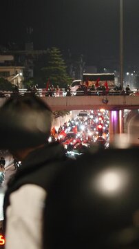 Vietnamese soccer fans celebrating victory at night on the street