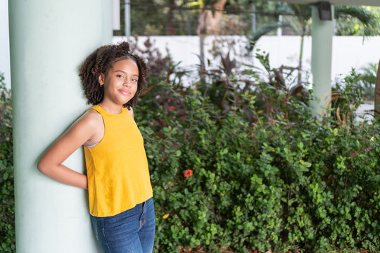 Smiling confident young teen girl standing outdoors