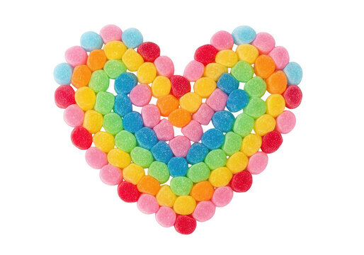 Colorful heart shape made of small round sugar candies arranged in a rainbow pattern design