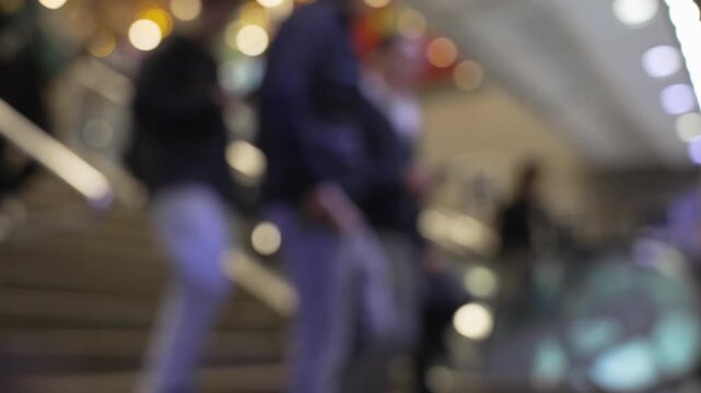 Blurred people walking on stairs and escalator in modern city, urban crowd background