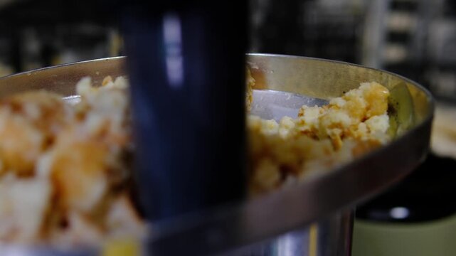 Grinding milk soaked bread through meat grinder for homemade patties, preparing classic binding ingredient for traditional recipes, vertical video