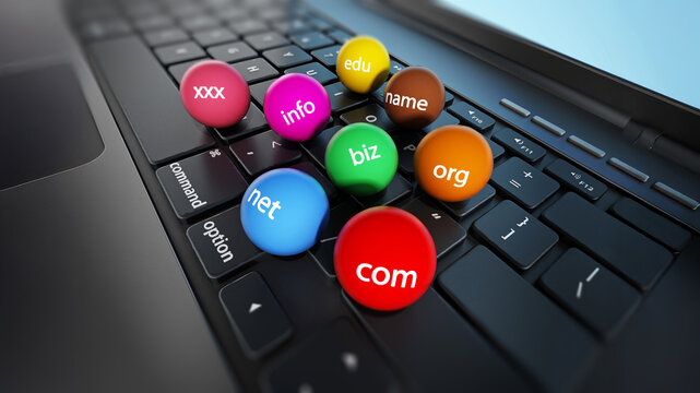 Domain name spheres standing on laptop computer keyboard. 3D illustration