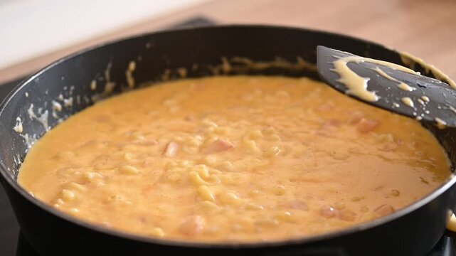 Cooking creamy homemade mac and cheese in a skillet