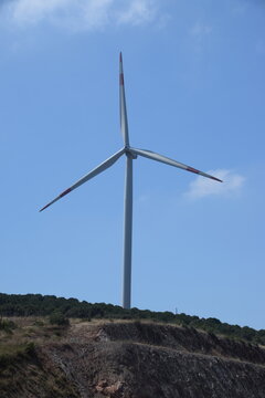 Windmills photographed against a clear sky background.