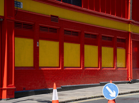 Bright red and yellow painted building on city street