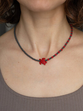 Fashion portrait of woman wearing gemstone jewelry necklace - warm neutral aesthetic with natural beauty style