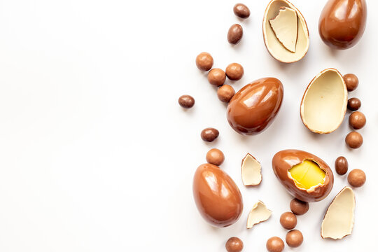 Various chocolate eggs and candies, top view. Sweet food and dessert background