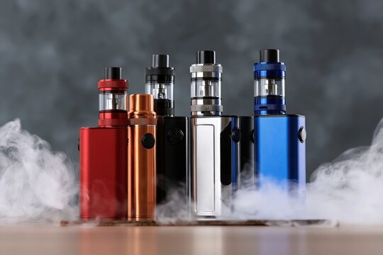The Colorful Vape Mods Display with Tanks and Cloudy Mist Surroundings