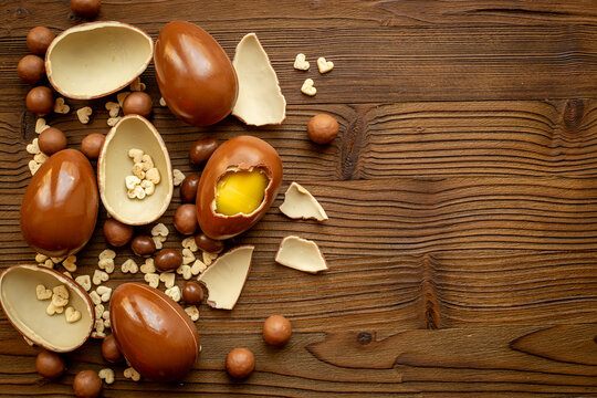 Various chocolate eggs and candies, top view. Sweet food and dessert background