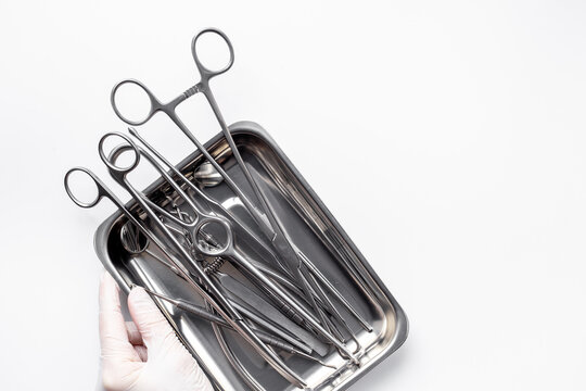 Sterile surgical instruments and tools - scalpels, scissors and others - in a stainless tray, top view