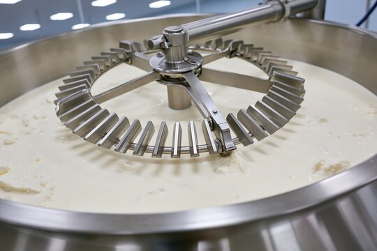 The Industrial Dairy Mixer with Precision Agitator Blades Circling Cream