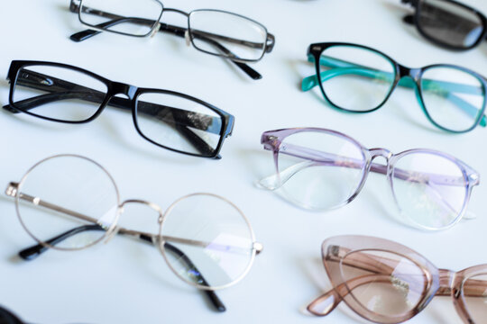 Set of glasses with different frame in optics store. Eyesight and vision concept.