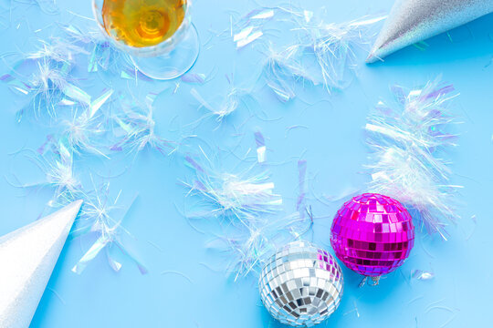 Disco balls with confetti and party hats, top view. Party time concept.
