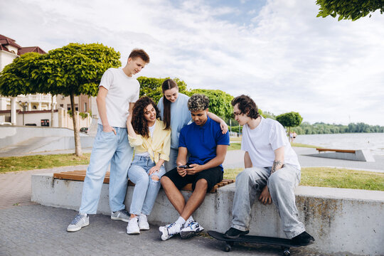Multiethnic teenagers sharing moments looking at smartphone