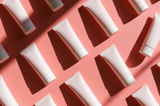 The Cosmetic Tubes on a Pink Background in Modern Flatlay Style