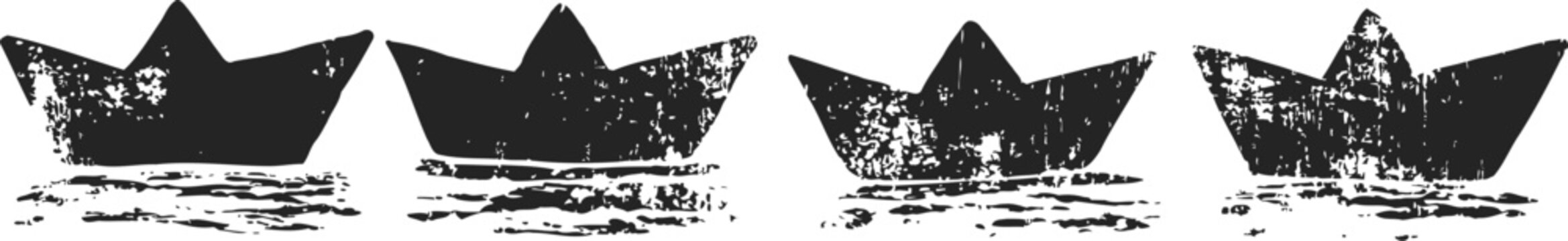 Four paper boats with crown shapes floating on water surface in a row