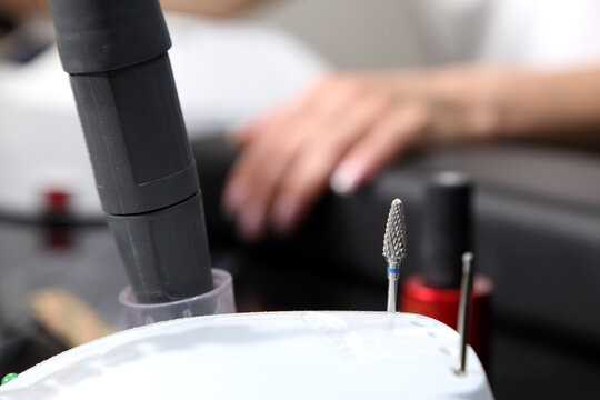 A woman's hand during a manicure. A woman getting a manicure. A manicurist is doing a client's nails at a nail salon. Manicure services. Nail art. Beauty salon.