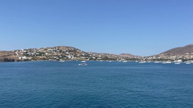 POV of a powerful sea wake from the stern of a ferry leaving Paros harbor in Greece