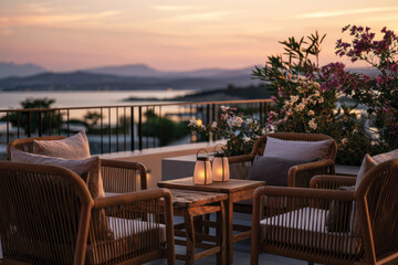 Fototapeta premium A beautifully arranged balcony showcasing stylish chairs and lanterns, accented by colorful flowers, providing a charming view of the serene sea and sunset sky.