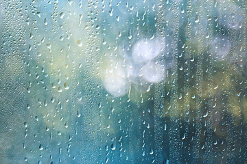 Fototapeta premium Light green gradient raindrops on glass abstract blurred background gentle summer soft green