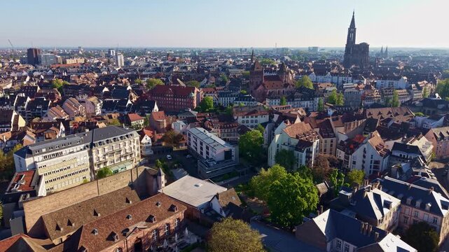 Eglise Saint-Thomas and Notre Dame cathedral, Strasbourg historic city center in France. Aerial drone flyback