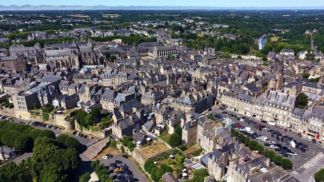 Historic center of Dinan, Cotes-d'Armor, Brittany, France, featuring Place Du Guesclin, Saint-Sauveur Basilica, Saint-Malo Basilica, Clock Tower, Dinan Viaduct and the Rance River, slow drone slide