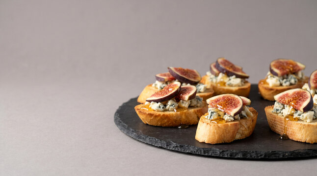 Catering appetizers of crostini with blue cheese and fig close up