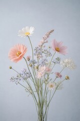Obraz premium Delicate pastel wildflower bouquet with pink and white blooms on soft gray background