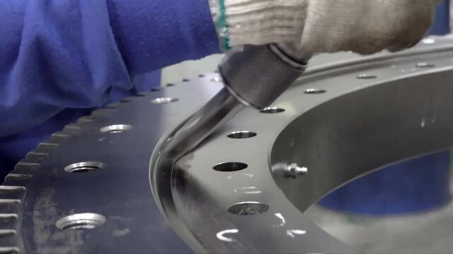 Detailed steps for industrial gear ring lubrication and seal maintenance involve applying grease to metal surfaces and installing protective gaskets for precision machinery operation.