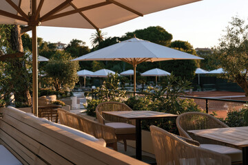 Fototapeta premium A beautifully designed outdoor dining space, complete with stylish furniture and chic umbrellas, perfect for enjoying meals in a serene garden environment.