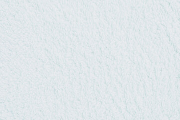 Horizontal close up of a soft fluffy white sherpa fleece textile texture showing cozy delicate plush fibers on a warm blanket or winter clothing surface © moryachka