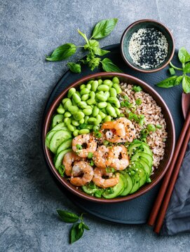 Shrimp rice bowl with edamame cucumber and sesame