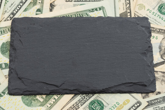 Blank chalkboard on twenty dollar bills for the cost of education
