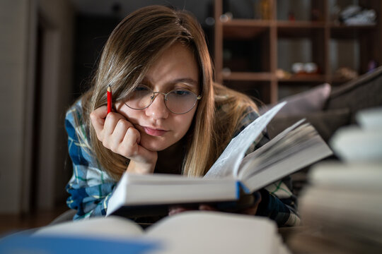 A woman reads a book at night. Studying, tired girl , night and learning for exam, exhausted of research. Bored, college student answers of test, paper and person with bulb for dark