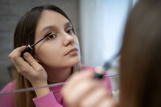 Mascara, makeup and face of woman in studio for wellness, beauty and cosmetics on gray background. Cosmetology, salon aesthetic and girl with eyelash brush for application, lash extension and glamour