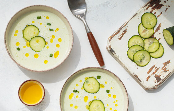 Cold cucumber yogurt soup bowls white flat lay summer natural light top view