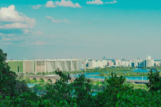 Modern city skyline panorama from a park hill terrace. Scenic view of residential buildings